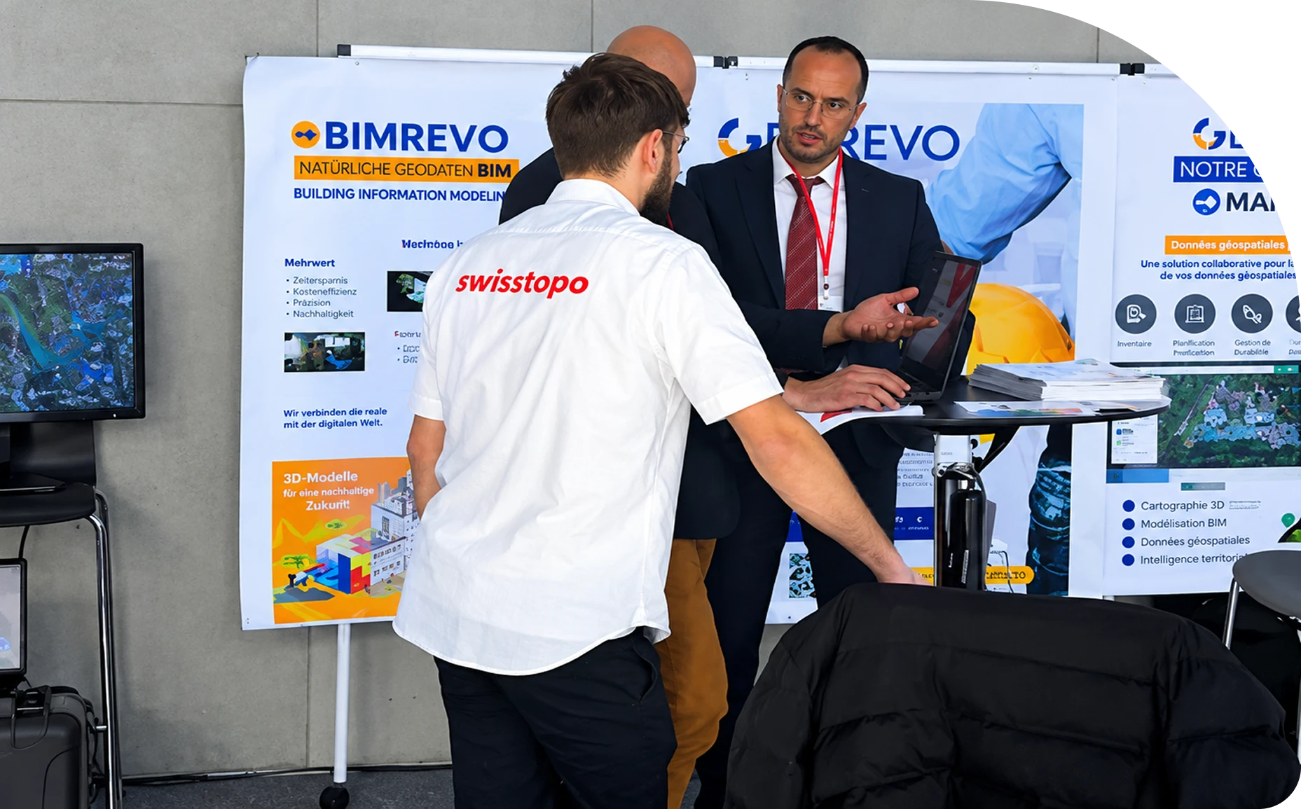 The GEOREVO team at their stand, in front of the BIMREVO and MAPREVO banners