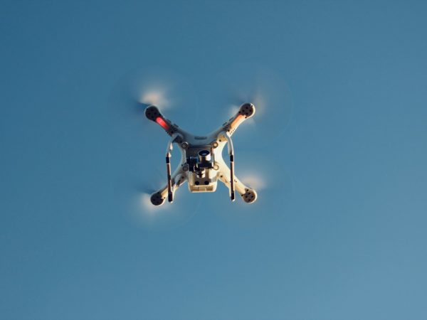low angle photography of RC quadcopter at mid air