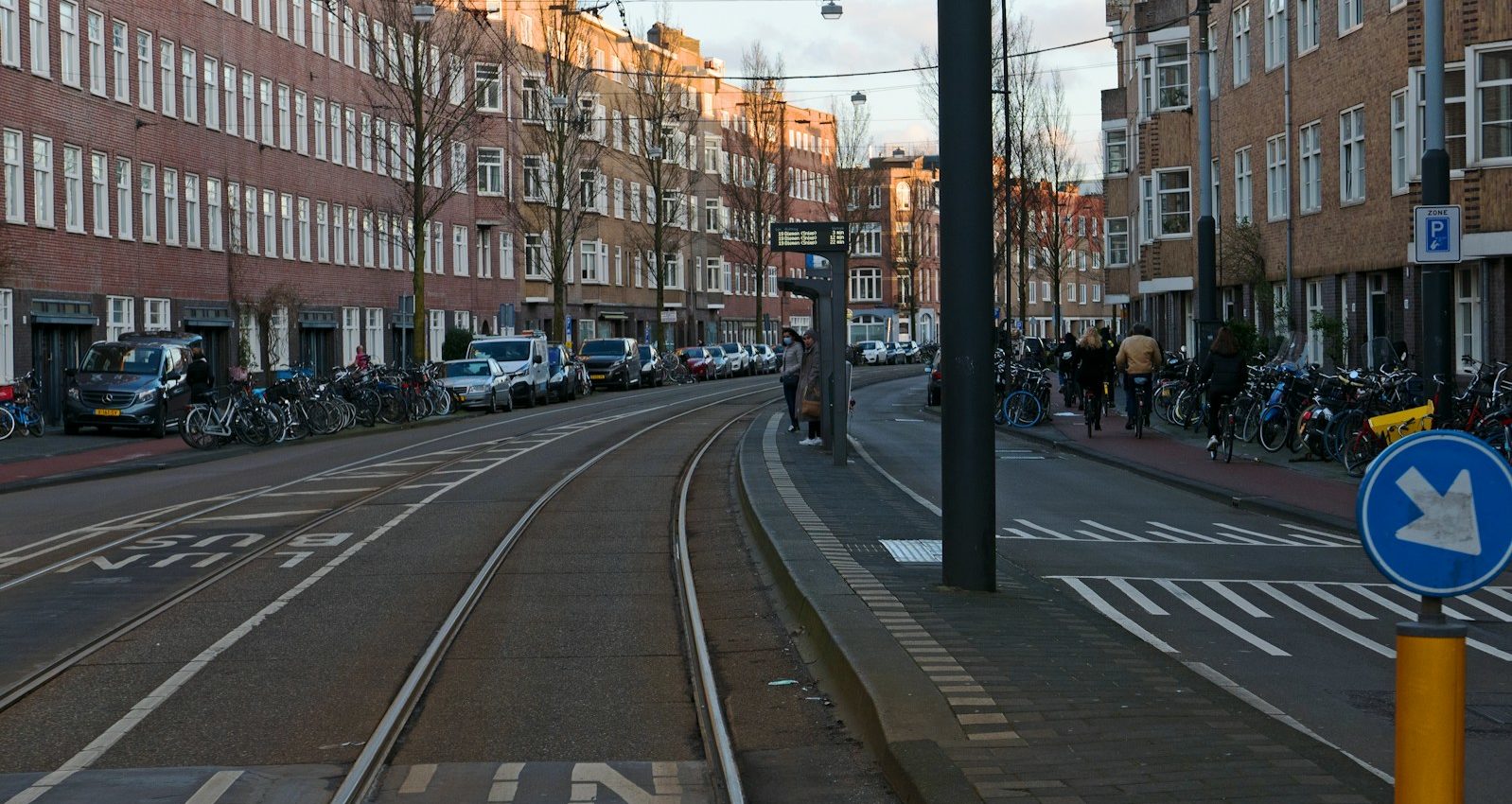 a street with cars and people