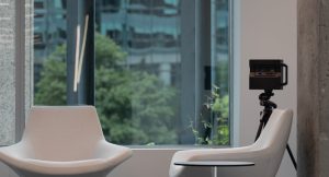 a room with a chair, a chair and a camera in it