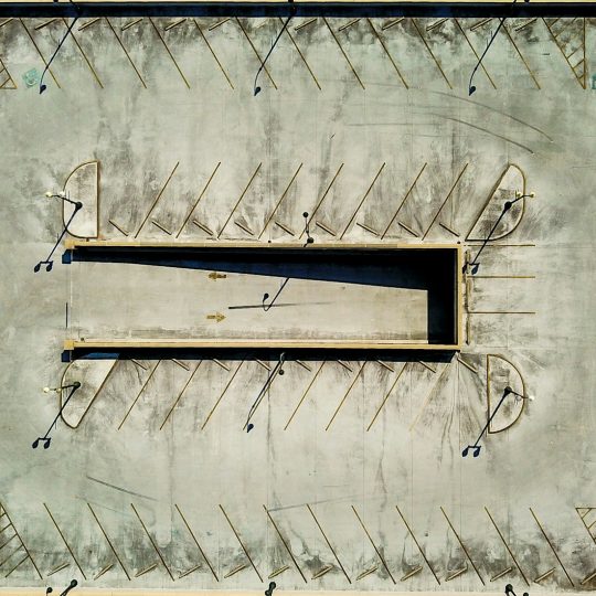 an aerial view of a parking lot with several empty benches