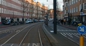 a street with cars and people